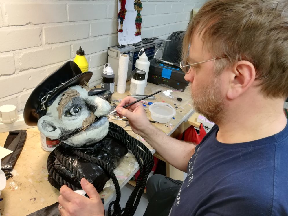 Timo maalaa rakentamansa nuken kasvoja.