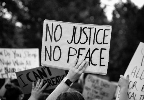 Kyltissä lukee No justice, no peace eli ei oikeutta, ei rauhaa